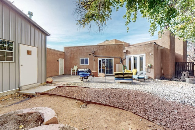 rear view of property with a patio area, french doors, and an outdoor hangout area