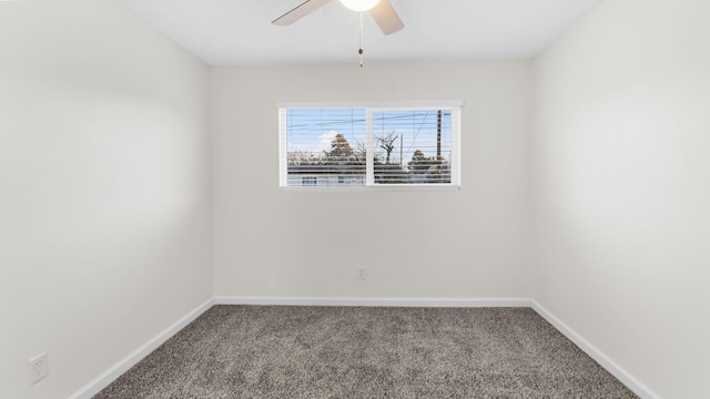 unfurnished room with ceiling fan and carpet