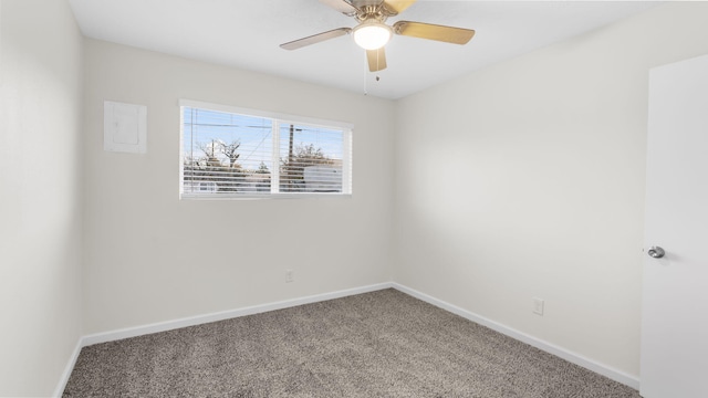 spare room featuring ceiling fan and carpet floors