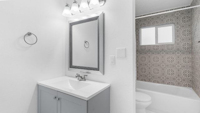 full bathroom with vanity, tiled shower / bath combo, and toilet