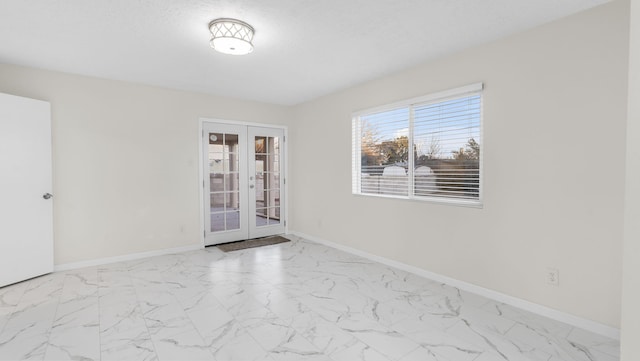 unfurnished room with french doors