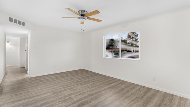 empty room with ceiling fan and wood-type flooring