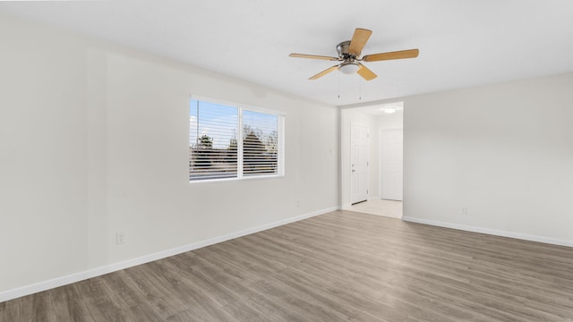 empty room with hardwood / wood-style flooring and ceiling fan