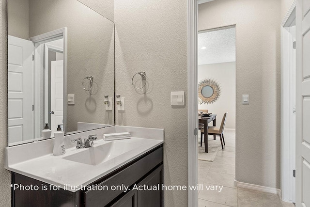 bathroom with tile patterned flooring and vanity