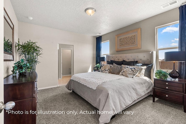 carpeted bedroom featuring a textured ceiling