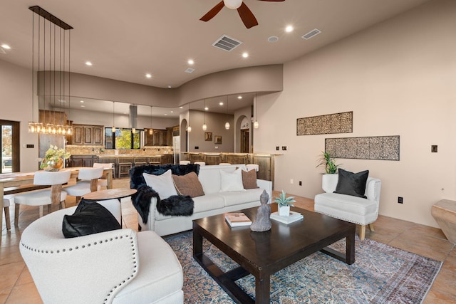 living room with ceiling fan and light tile patterned floors