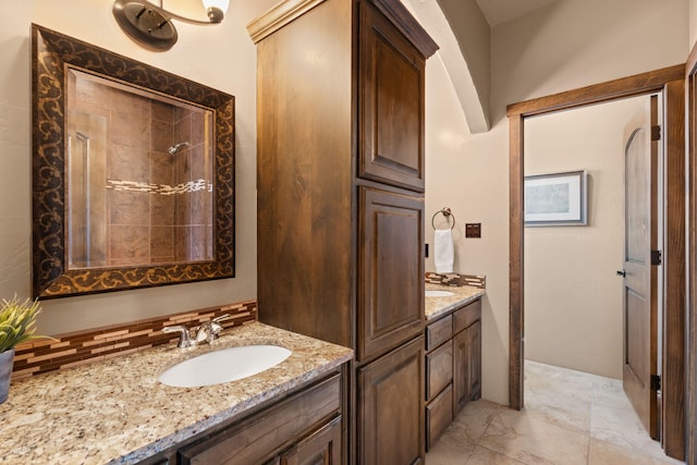 bathroom with vanity and tasteful backsplash