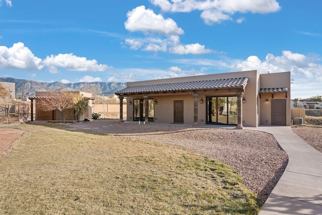 rear view of property featuring a mountain view and cooling unit