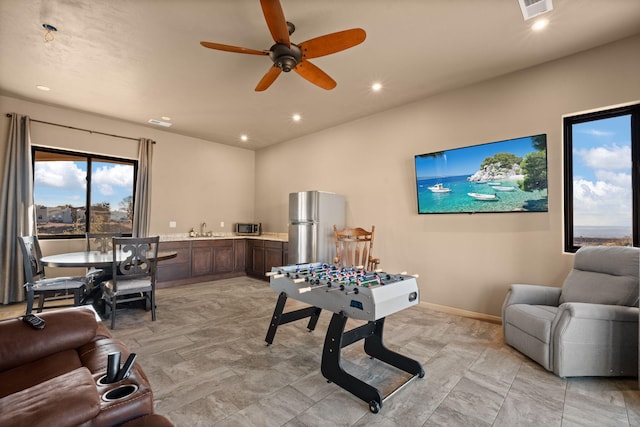 playroom featuring ceiling fan and sink