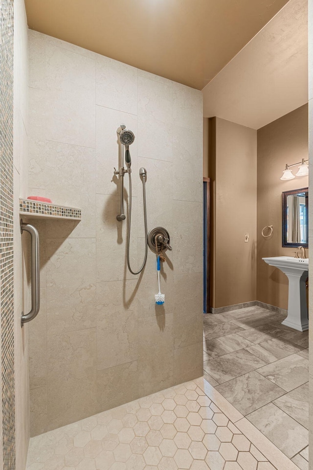 bathroom with sink and tiled shower