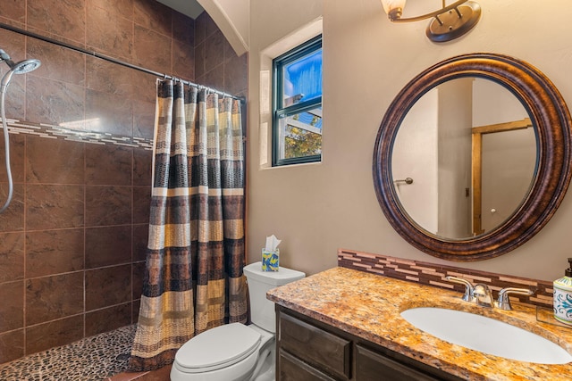 bathroom with tasteful backsplash, toilet, vanity, and walk in shower