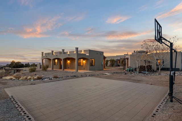 exterior space featuring basketball court and a patio area