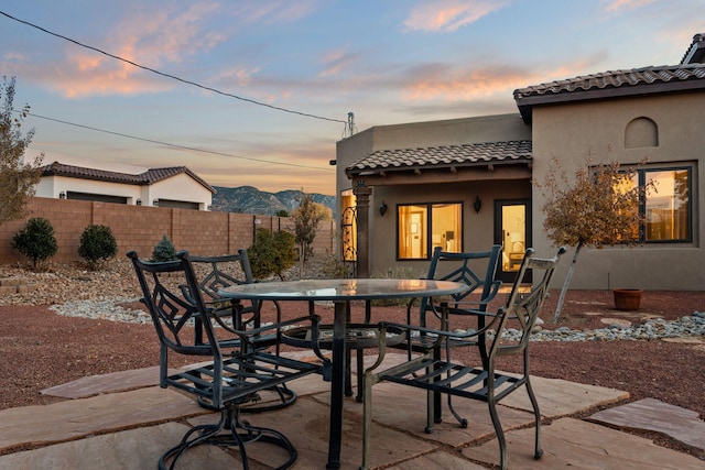 patio terrace at dusk with a mountain view