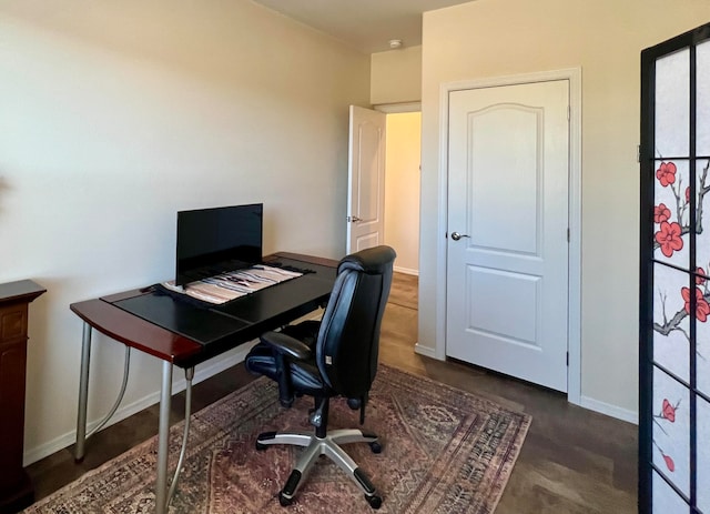 office with dark hardwood / wood-style floors