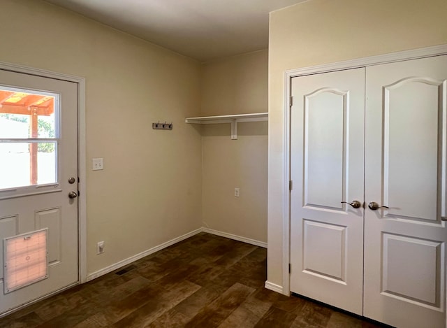 laundry room with dark wood-type flooring