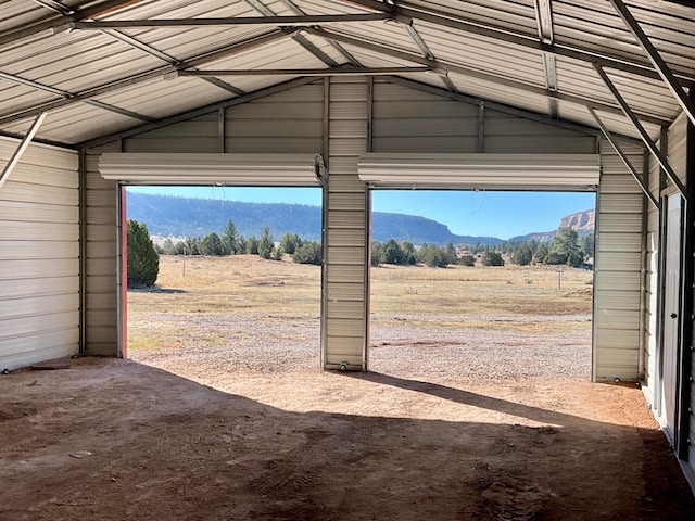 garage with a mountain view and a rural view