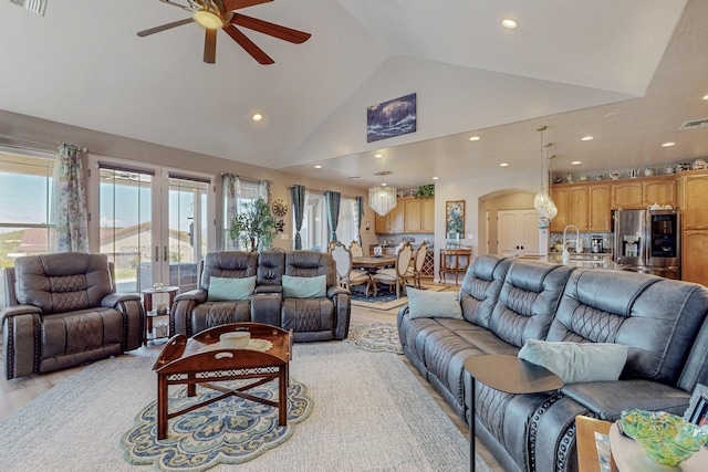 living area featuring arched walkways, recessed lighting, visible vents, ceiling fan, and high vaulted ceiling