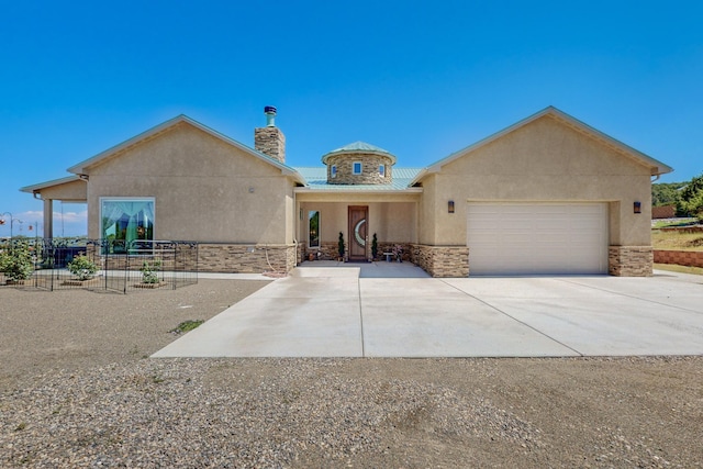 view of front of property with a garage, stone siding, concrete driveway, and stucco siding