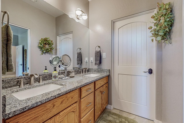 bathroom with a sink and double vanity