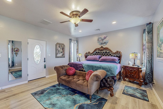 bedroom featuring baseboards, visible vents, wood finished floors, and recessed lighting