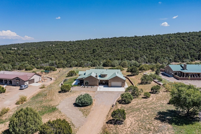 drone / aerial view featuring a forest view