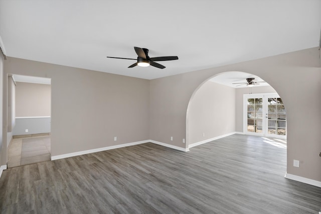 empty room with dark hardwood / wood-style floors and ceiling fan