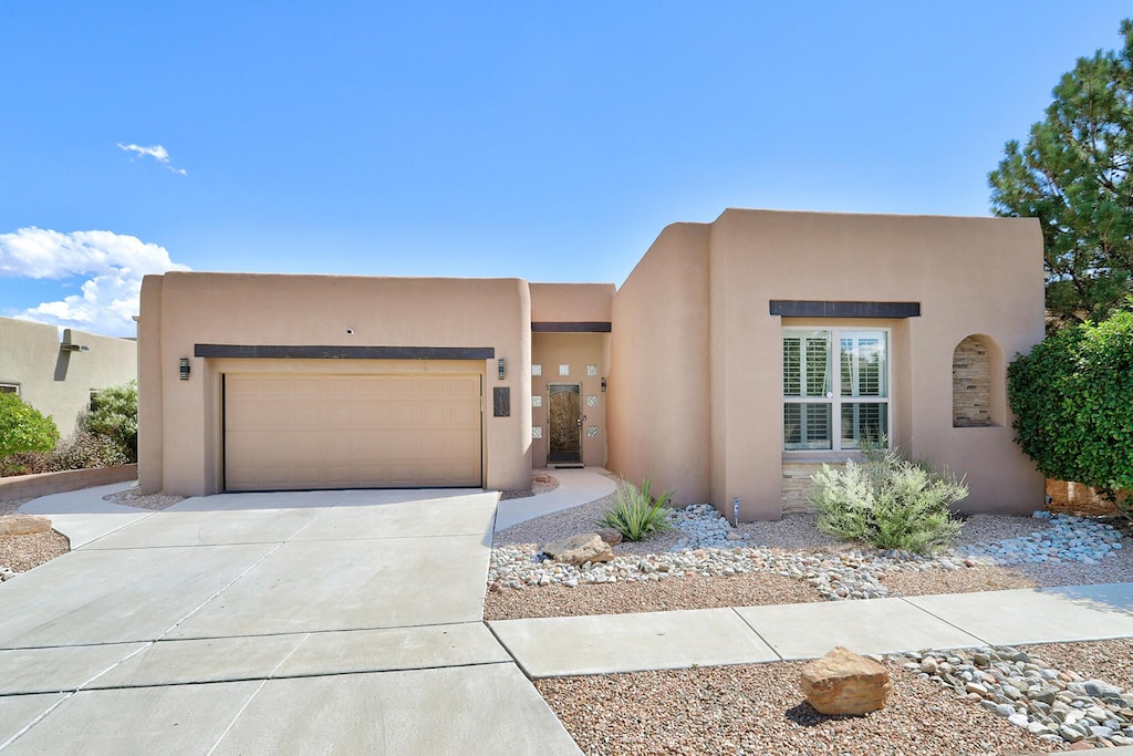 southwest-style home featuring a garage