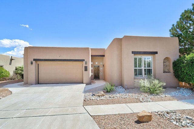 southwest-style home featuring a garage