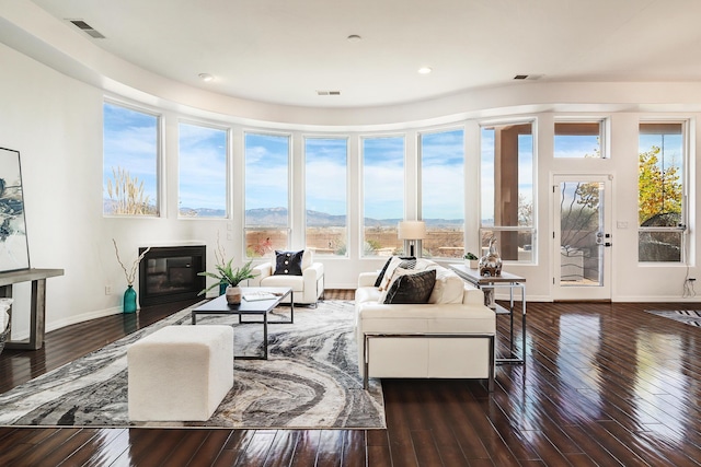 living room with a mountain view and dark wood-type flooring