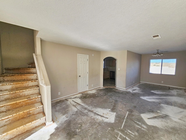 foyer with a textured ceiling and an inviting chandelier