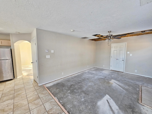 spare room with a textured ceiling and ceiling fan