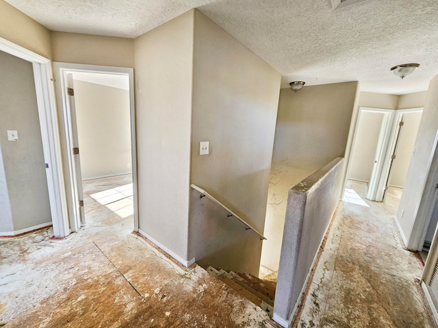 hallway featuring a textured ceiling