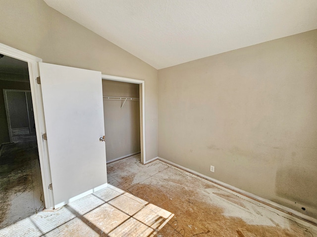 unfurnished bedroom with a closet and vaulted ceiling