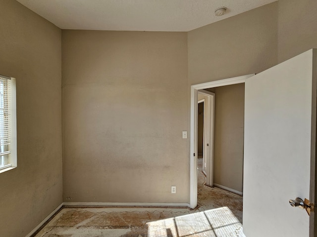 unfurnished room with a textured ceiling