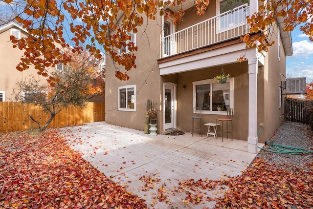 rear view of property with a patio area and a balcony