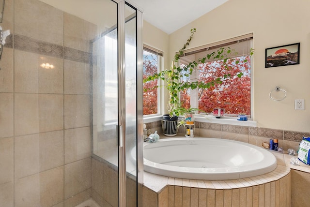 bathroom featuring shower with separate bathtub