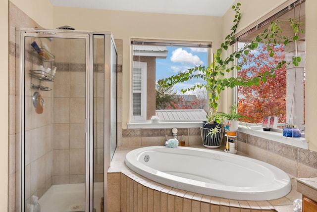 bathroom featuring separate shower and tub