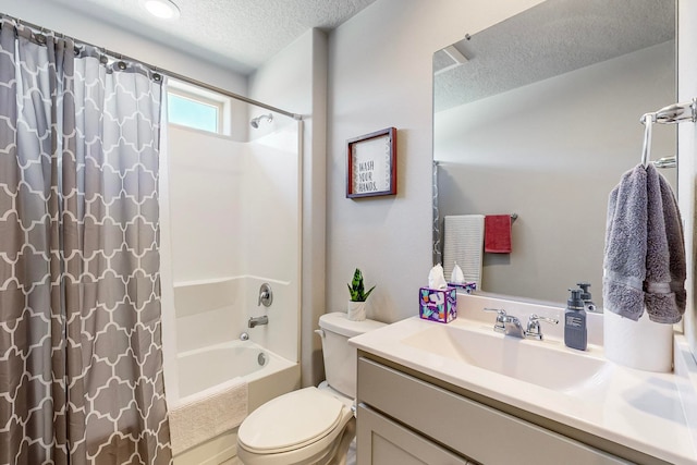 full bathroom with vanity, a textured ceiling, toilet, and shower / bath combo with shower curtain