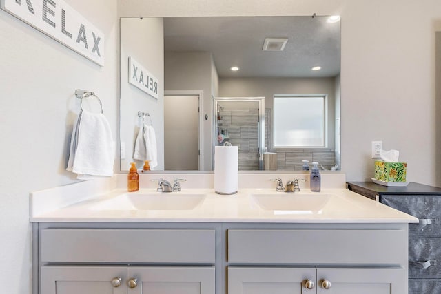 bathroom with vanity and a shower with door