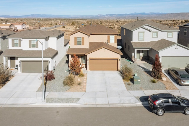 front of property with a mountain view and a garage