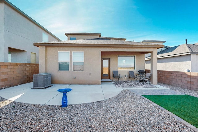 back of property featuring central air condition unit and a patio