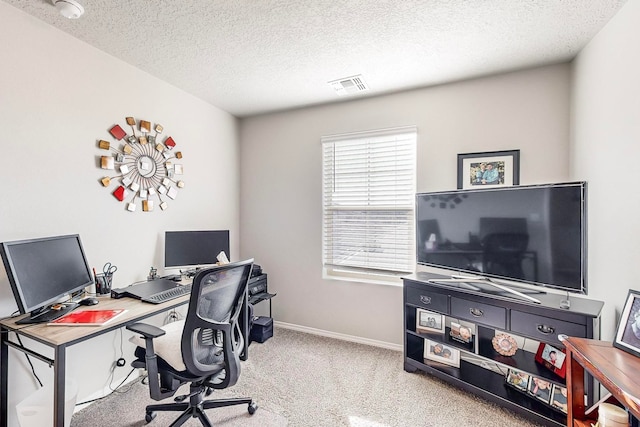 office area featuring light carpet and a textured ceiling