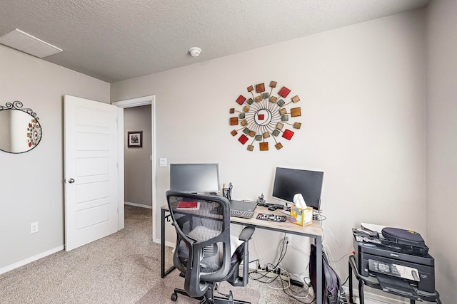 carpeted office space featuring a textured ceiling