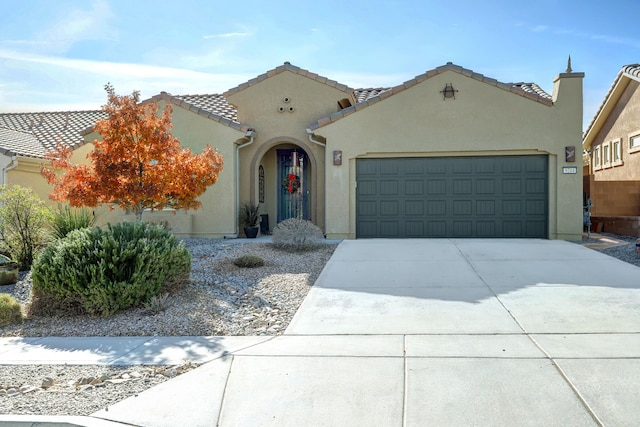 mediterranean / spanish home featuring a garage