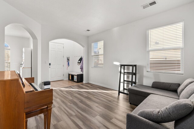 6923 Wrangell Loop NE, Rio Rancho, NM 87144 - living area featuring arched walkways, light wood-style floors, and baseboards