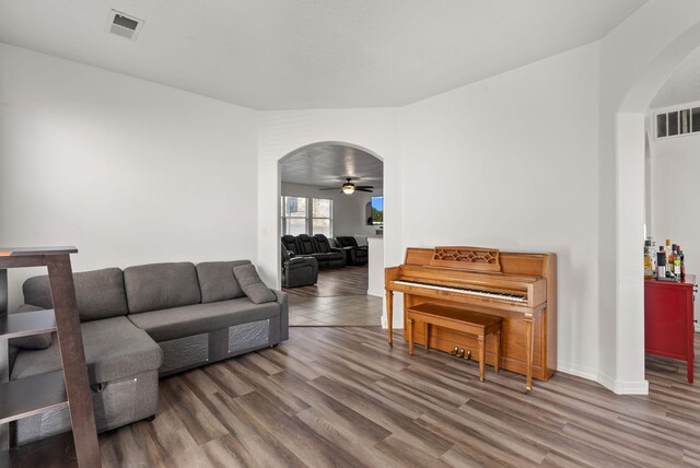 6923 Wrangell Loop NE, Rio Rancho, NM 87144 - living room featuring arched walkways, wood finished floors, and ceiling fan