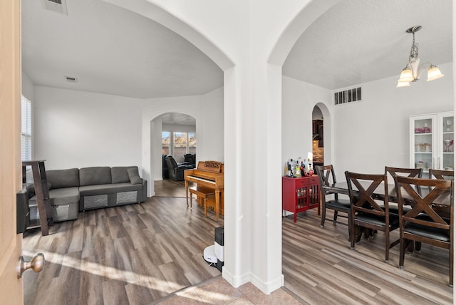 interior space with a chandelier and light hardwood / wood-style floors