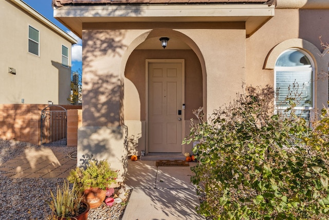 6923 Wrangell Loop NE, Rio Rancho, NM 87144 - doorway to property with stucco siding and a gate