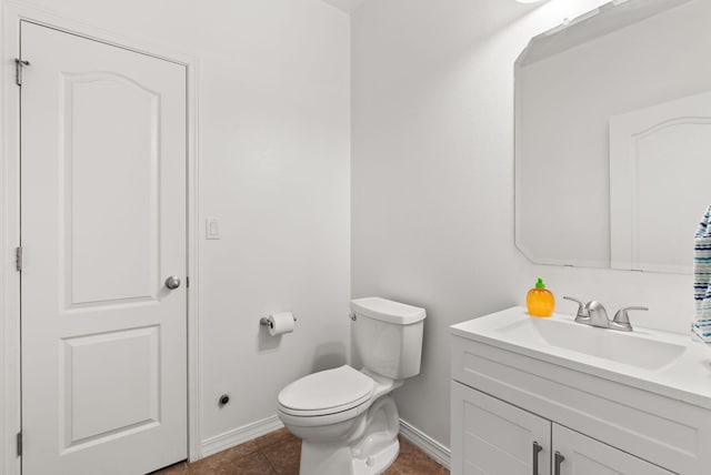 bathroom with tile patterned floors, vanity, and toilet