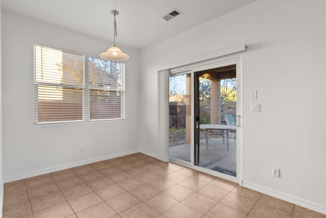 unfurnished dining area with light tile patterned floors